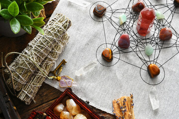 Wall Mural - A top view image of a healing crystal grid using healing crystals and sacred geometry with white sage smudge sticks. 