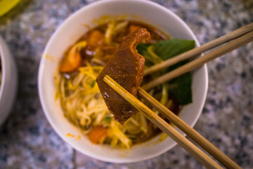 Vietnam food, noodle with stewed beef, a popular meal at morning, eat attach parsley, basil, lemon pepper and salt make so delicious taste. Hu tieu bo kho