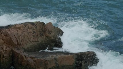 Poster - Sea wave splash over the rock and stone in slow motion