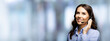 Call center help line service. Portrait of customer support phone sales operator in headset, over blurred modern office interior background. Young brunette business woman, indoors.