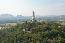 Aerial View Of Wat Nong Hoi Park, White Buddha Pagoda Stupa In A Temple Park, Ratchaburi, Thailand With Green Mountain Hills And Forest Trees. Thai Buddhist Temple Architecture. Tourist Attraction.