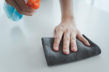 Unrecognizable Asian Housekeeper Using Microfiber Wiping On A Surface Of Table Close Up With Copyspace. Maid Cleaning And Sanitizing On A Dirty Surface.