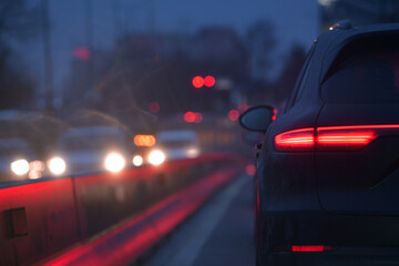 Wall Mural - Cars staying in the morning traffic. Traffic jam on the streets of Bucharest, detail with the LED rear car light.