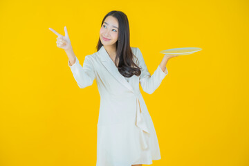 Wall Mural - Portrait beautiful young asian woman smile with empty plate dish