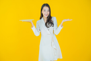 Wall Mural - Portrait beautiful young asian woman smile with empty plate dish