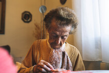 Retired Elderly Woman Knitting At Home