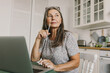 Thoughtful senior woman have bright idea. Deep in her thoughts. Talented journalist or author think about book. Remote work, home office, inspiration, poet, hobby concept