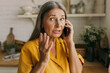 © shurkin_son - Attarctive retired female gesticulating with anxiety talking on phone, having worried face, using smartphone for conversation wih bank, trying to solve problem with savings account