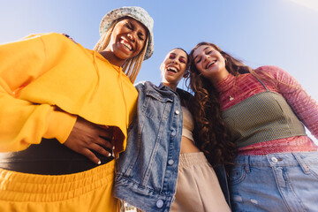 Bottom view of three girls laughing cheerfully