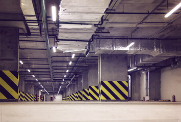 Wall Mural - Empty parking place in a residential building. Covered underground parking for cars