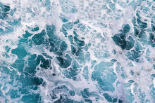 Raging Sea With Foam On The Crest Of A Wave. Blue Water Background
