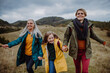 © Halfpoint - Happy small girl with mother and grandmother hiking outoors in autumn nature.