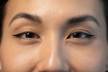 Close up of beautiful young asian woman with brown eyes