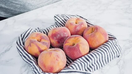 Wall Mural - Organic whole peaches in a metal wired basket.