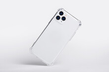 Silver IPhone 11 And 12 Pro Max In Clear Silicone Case Falls Down Back View, Phone Case Mockup Isolated On Gray Background
