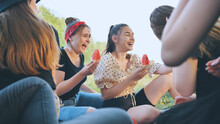 Friends Have Fun Eating Watermelon Outside The City At A Picnic.