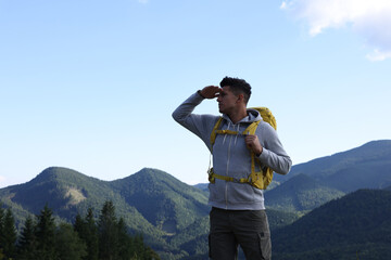 Canvas Print - Tourist with backpack in mountains, space for text