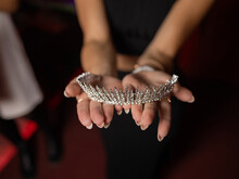 Close Up Of Hands Showing A Trendy Bridal Silver Wide Diadem.