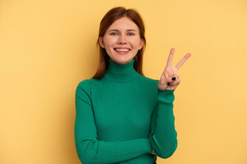 Young English woman isolated on yellow background showing number two with fingers.