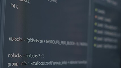 Closeup of computer screen of system engineer typing source code in it startup agency. Display concept of software developer writing programming language. Scrolling text of database functions script.