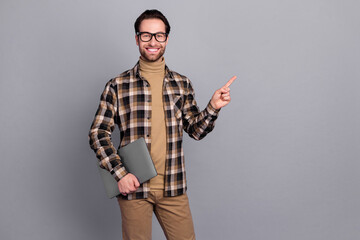 Wall Mural - Photo of positive guy dressed checkered shirt glasses holding device empty space isolated grey color background