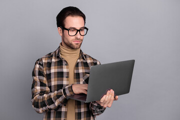 Poster - Photo of sweet confident guy dressed checkered shirt glasses typing modern device isolated grey color background