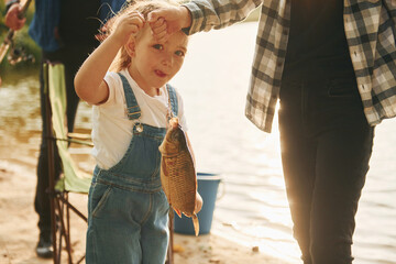 Wall Mural - Father with son and daughter on fishing together outdoors at summertime