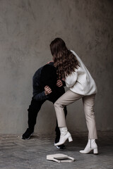 Poster - Woman defending herself from attacker near beige wall outdoors