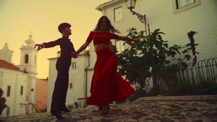 Wall Mural - Beautiful Couple Dancing a Latin Dance on the Quiet Street of an Old Town in a City. Sensual Dance by Two Professional Dancers on a Sunset in Ancient Culturally Rich Tourist Location.