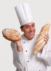 Baker cook holding two big breads on hand on white background portrait.