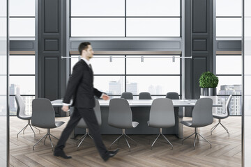 Aufkleber - Businessman walking in modern wooden and concrete meeting room interior with panoramic city view, furniture and daylight. Success and workplace concept.