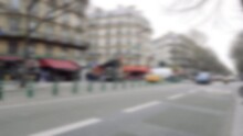 Defocused view of Parisian street with cars traditional buses and restaurants awning in background - blur cinematic 4k UHD footage