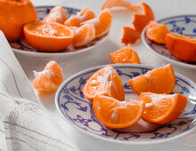 Sweet Mandarin Oranges On A White Blue Ceramic Plate. Side View.
