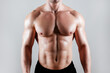© Evrymmnt - Professional bodybuilder posing over isolated white background. Studio shot of a fitness trainer flexing the muscles. Close up, copy space.