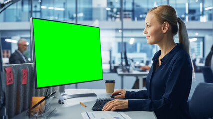 Poster - Diverse Modern Office: Confident Businesswoman Using Desktop Computer with Green Screen Mock Up Display. Manager Working on e-Commerce Support, Project Marketing, Data Analysis