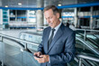 © zinkevych - Joyous businessperson reading a text message on his cellphone