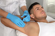 © New Africa - Cosmetologist injecting man's armpit in clinic. Treatment of hyperhidrosis