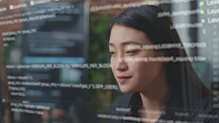 Wall Mural - Portrait of focused asian software developer through vfx of floating programming code writing and smiling sitting at desk. App developer looking at hologram of machine learning data algorithm.