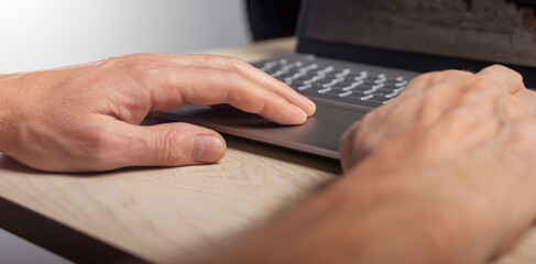 Poster - Hand on laptop touchpad, tapping and scrolling with fingers close up.