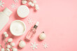 Leinwandbild Motiv Winter cosmetic, skin care product. Cream, serum, tonic with winter decorations. Top view on pink background with copy space.