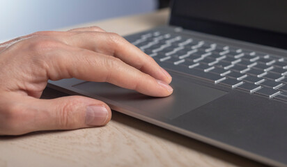 Poster - Fingers on laptop touchpad, scrolling process close up.