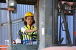 © FotoArtist - Female truck driver and Foreman control loading Containers box from Cargo freight ship for import export. Freight containers in sea port.