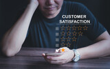 Fototapeta  - Customer dissatisfaction experience concept, business male customer hand-holding head, disappointed with bad service, by rating through smartphone, bad review, low rating, no service mind.
