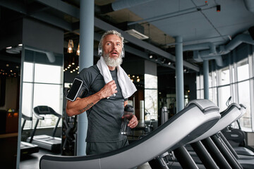 Wall Mural - Exhausted mature man after working out in sports center