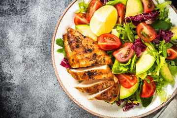 Healthy food concept. Diet menu. Grilled chicken with fresh salad. Top view image.