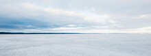 Frozen Forest Lake On A Cloudy Day. Dramatic Sky After A Blizzard. Onega, Karelia, Russia.Atmospheric Winter Landscape. Panoramic View. Nature, Climate Change, Christmas Vacations, Eco Tourism