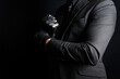 Portrait of Strong Man in Dark Suit Pulling on Black Leather Gloves Menacingly. Concept of Mafia Hitman or Gentleman Assassin.