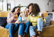 © Xavier Lorenzo - Cheerful multiracial female friends enjoying free time together at home - Three happy young adult women hanging out while - Friendship and social gathering concept