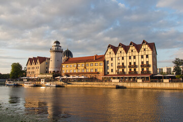 Wall Mural - The Fishing Village and lighthouse on the banks of Pregolya River at sunset light, Kaliningrad, Russia