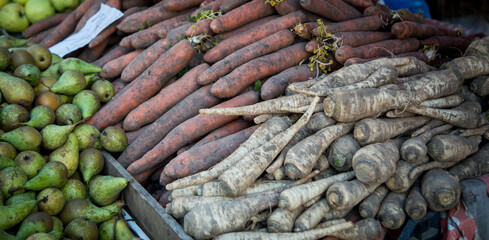 Wall Mural - fresh carrots and parsnips at a farmers market